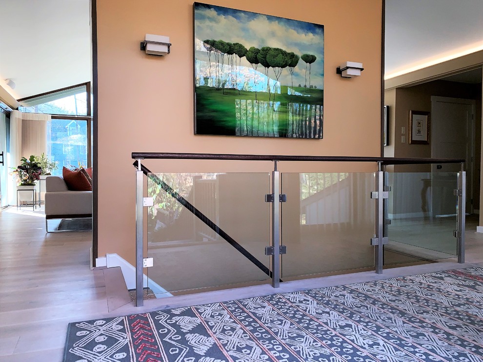 Design ideas for a contemporary straight glass railing staircase in Philadelphia.