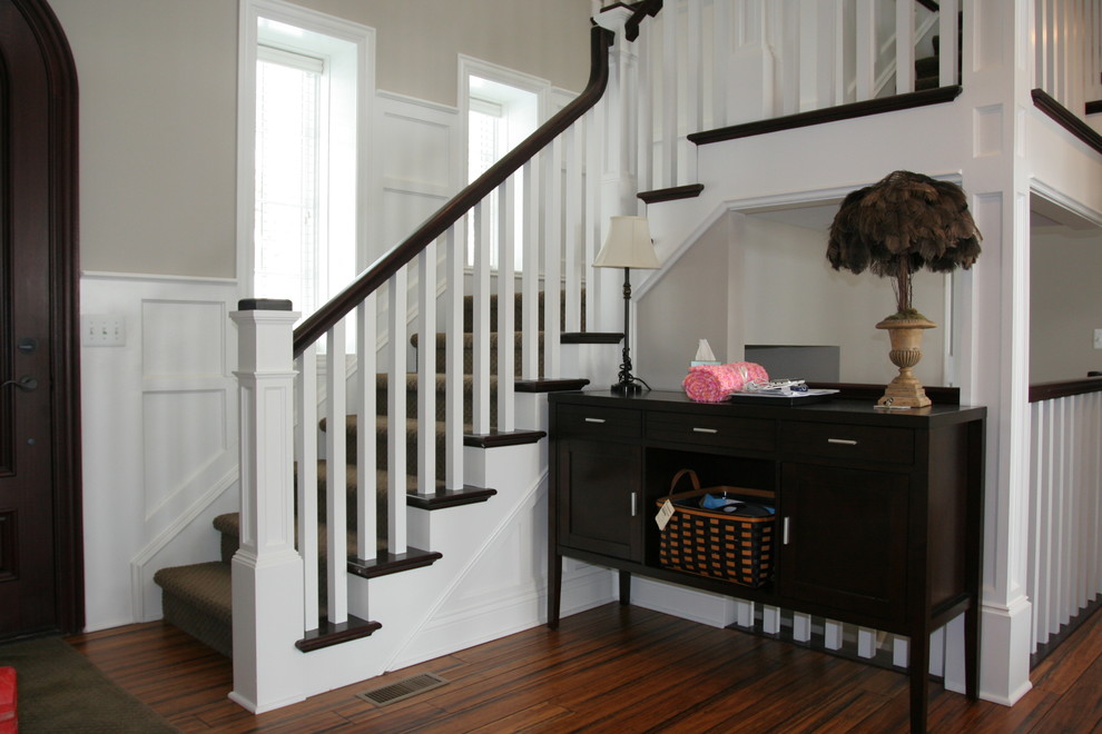 This is an example of a traditional staircase in Detroit with feature lighting.