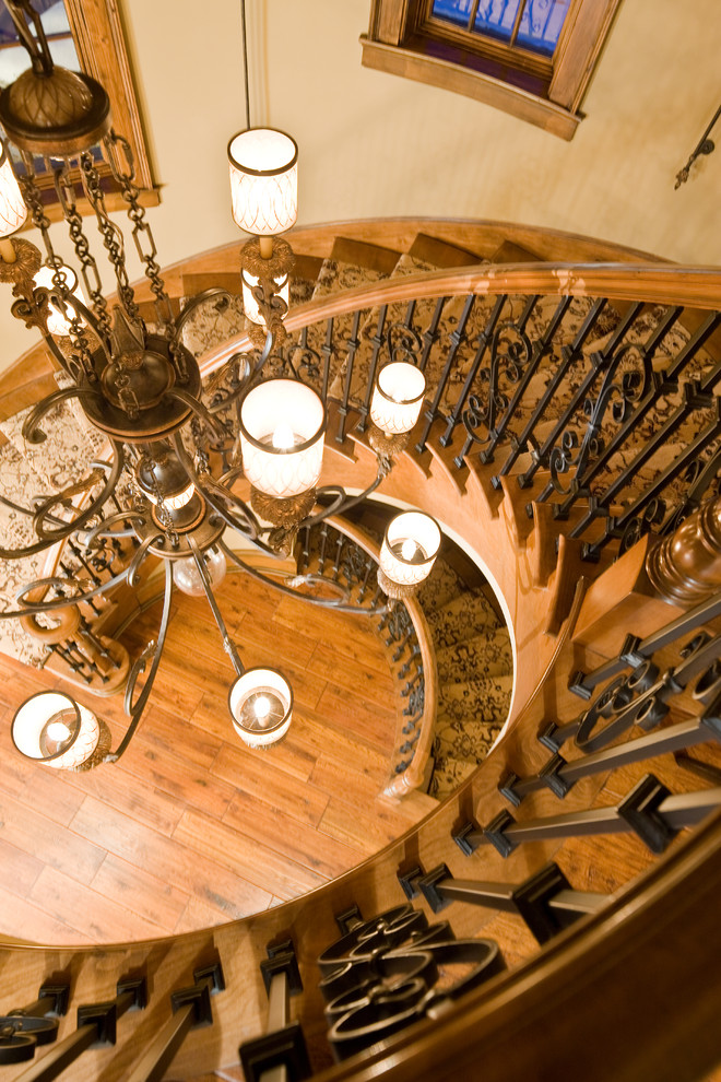 Inspiration for a large timeless wooden curved staircase remodel in Indianapolis with wooden risers