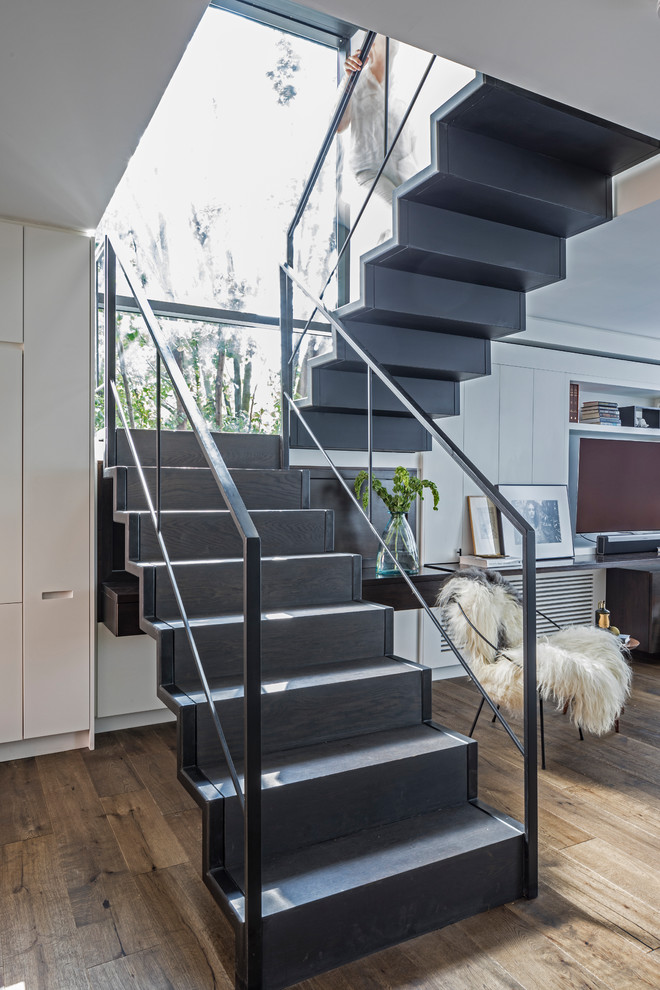Design ideas for a medium sized modern wood floating metal railing staircase in New York.
