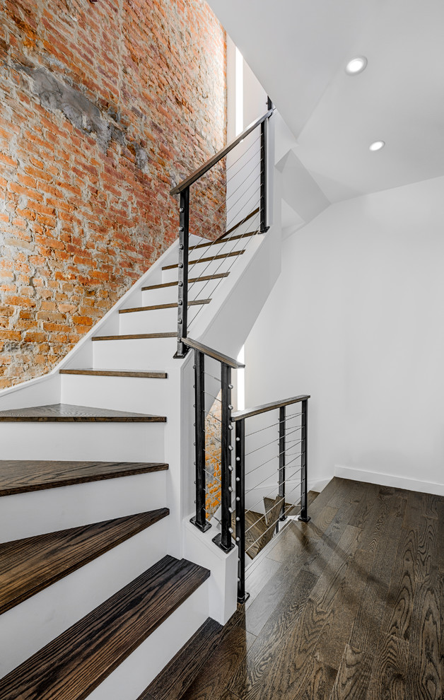 Inspiration for a small contemporary wooden curved cable railing staircase remodel in New York with wooden risers