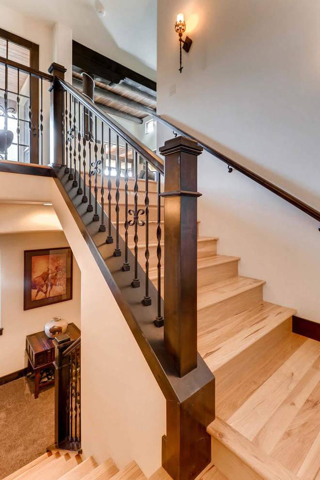 Photo of a medium sized wood u-shaped staircase in Denver with wood risers.