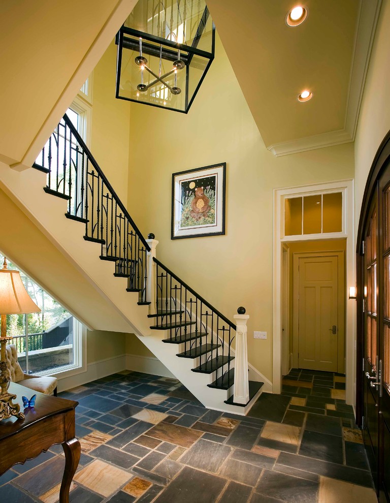 Photo of a classic painted wood u-shaped staircase in Other with painted wood risers and feature lighting.