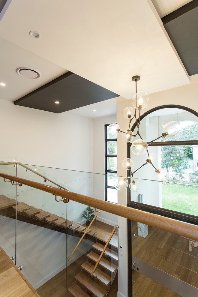 This is an example of a modern wood u-shaped staircase in Melbourne with wood risers.