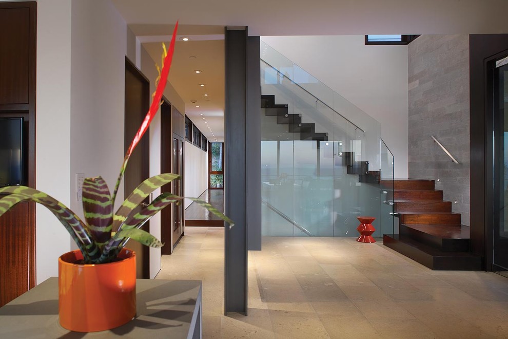 Design ideas for a modern wood l-shaped glass railing staircase in Orange County with wood risers.