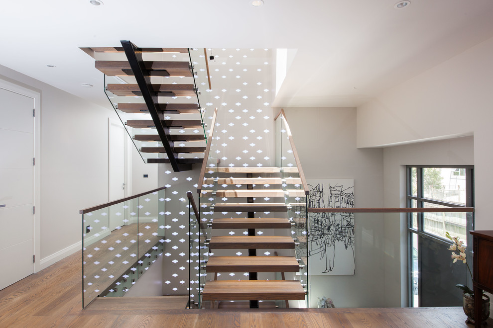 Mid-sized trendy wooden u-shaped open and glass railing staircase photo in Auckland