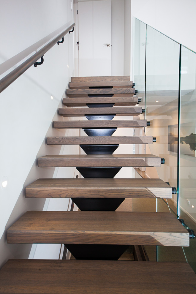 Large contemporary wood floating staircase in Auckland with open risers.