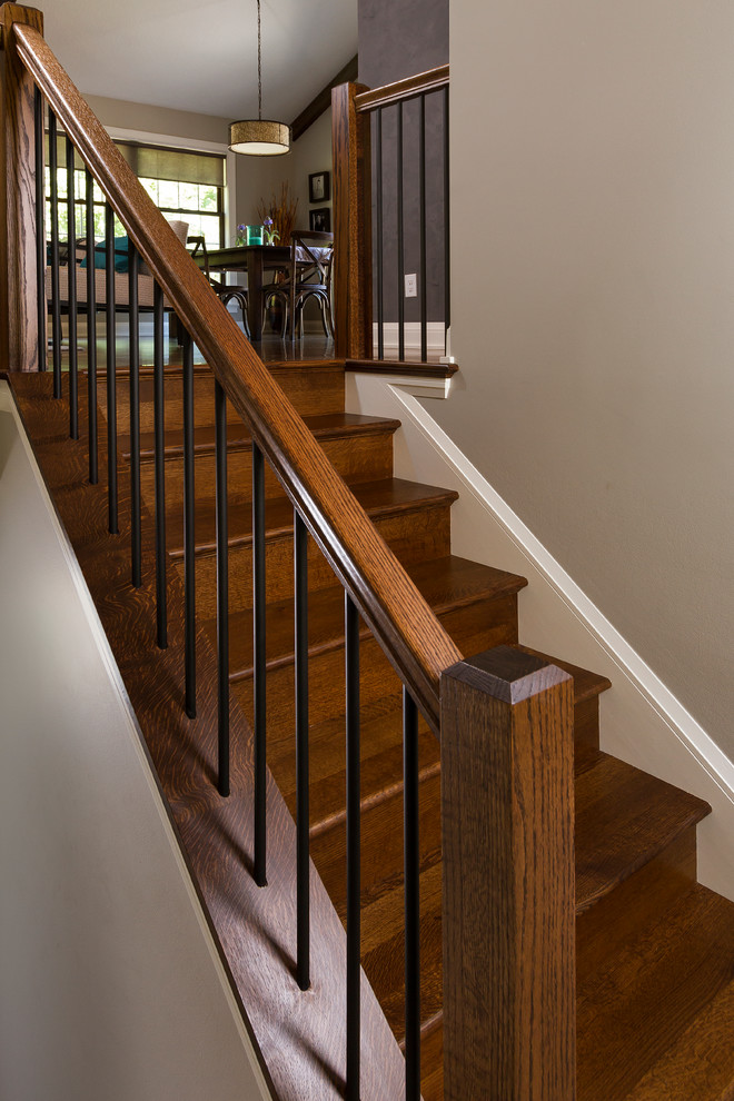 Example of a transitional wooden straight staircase design in Minneapolis with wooden risers