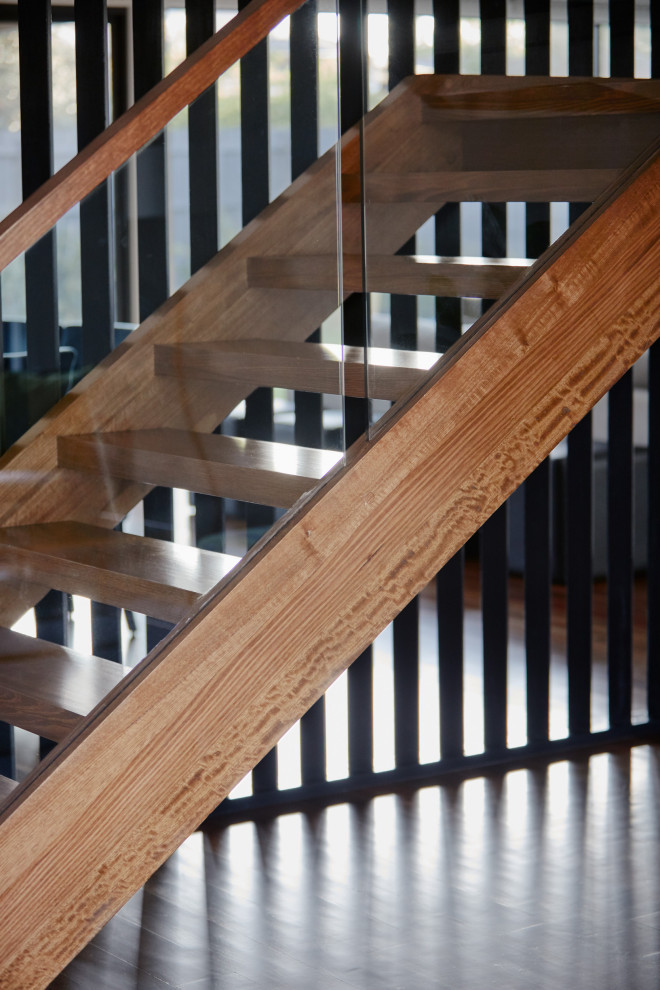 Photo of a medium sized contemporary wood u-shaped wood railing staircase in Melbourne.