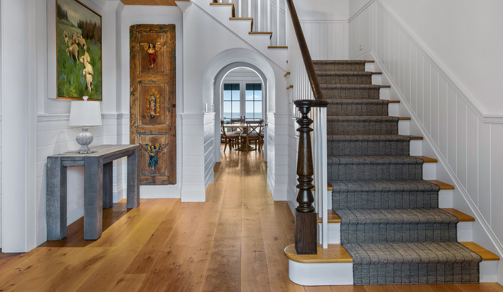 Design ideas for a large nautical wood wood railing staircase in Other with wood risers.