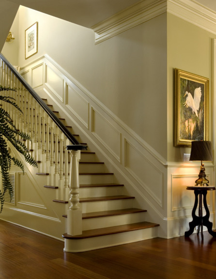 Photo of a traditional staircase in Charleston with feature lighting.
