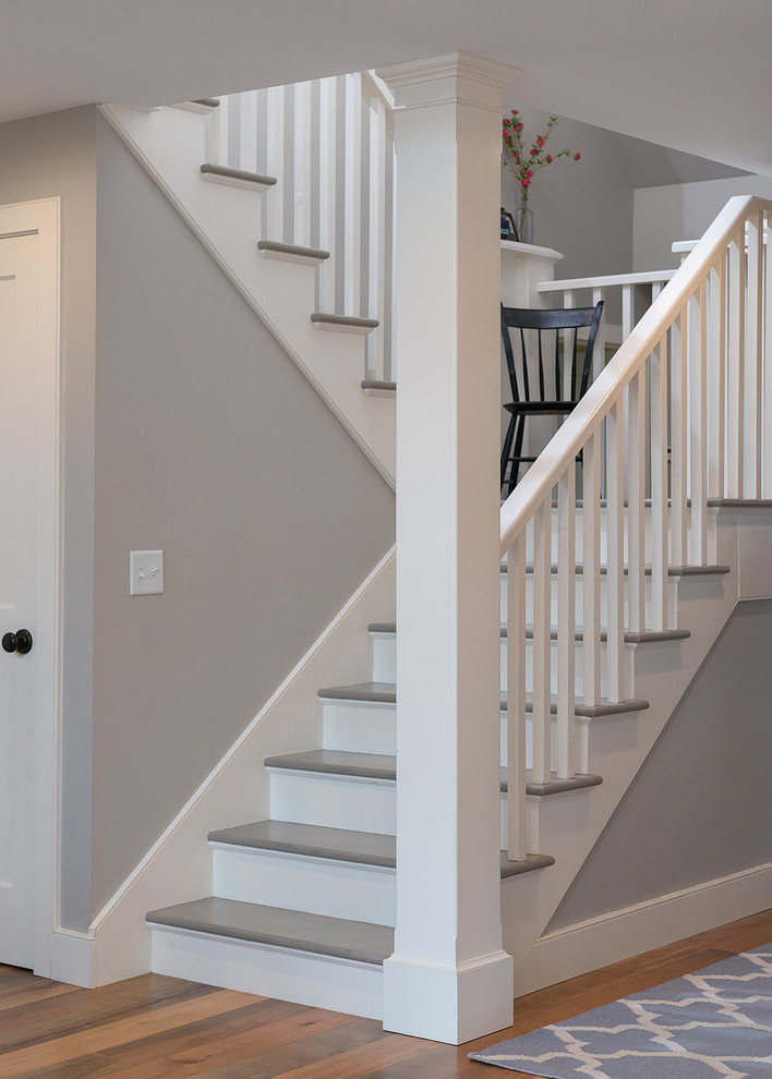 Inspiration for a medium sized farmhouse painted wood u-shaped staircase in Charlotte with wood risers.