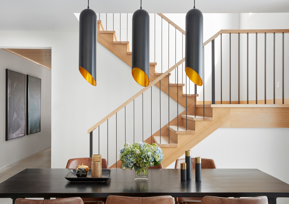 Ejemplo de escalera en U contemporánea de tamaño medio con escalones de madera, contrahuellas de madera y barandilla de madera