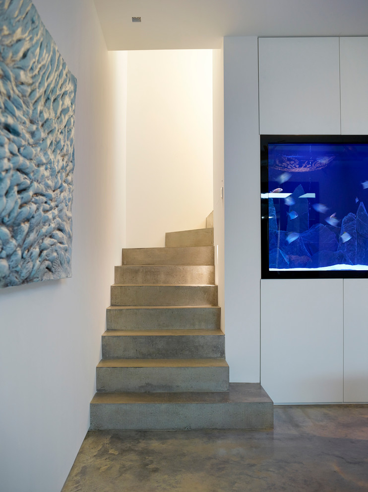 Photo of a medium sized contemporary concrete l-shaped staircase in London with concrete risers.