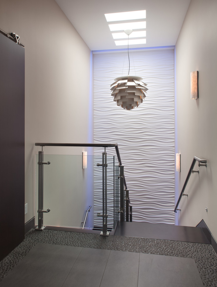Example of a mid-sized tile u-shaped glass railing staircase design in Houston with tile risers
