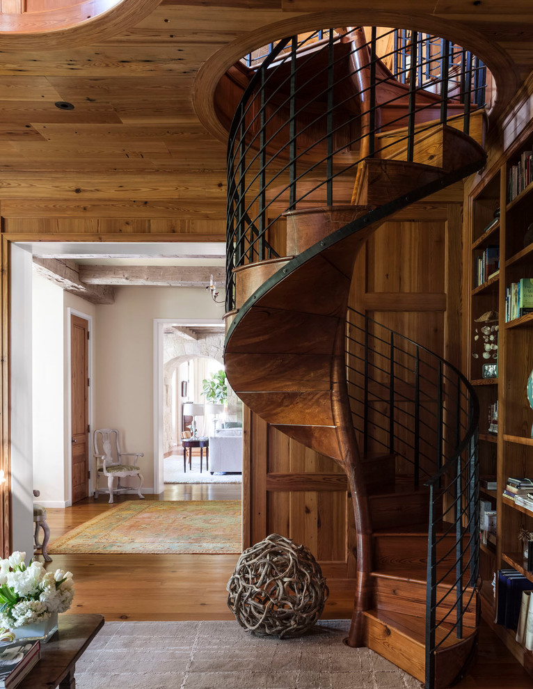 Staircase - transitional wooden spiral staircase idea in Dallas with wooden risers