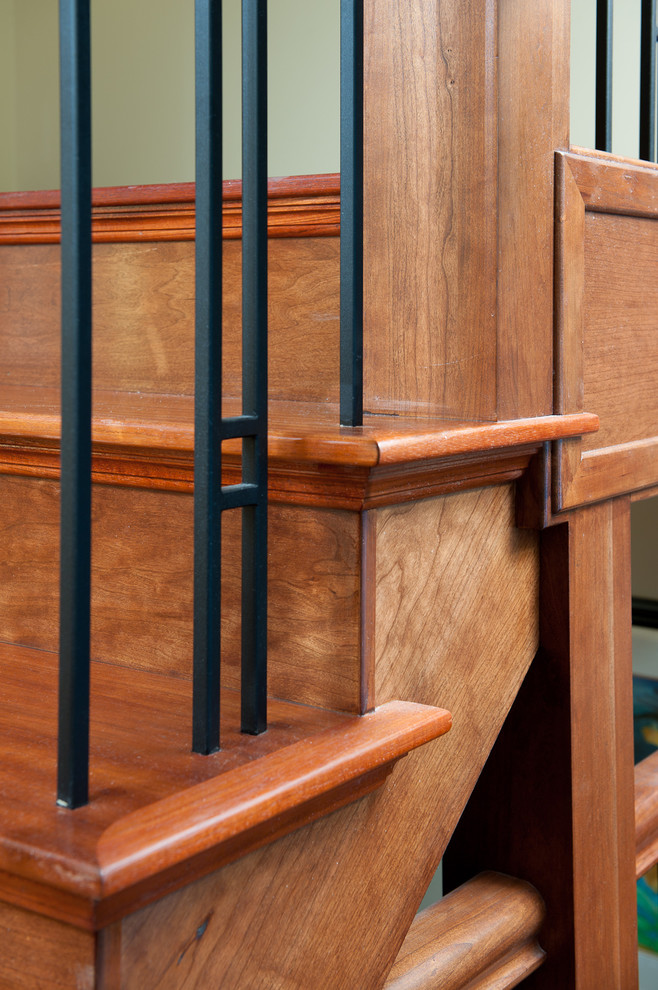 Cette image montre un escalier droit craftsman de taille moyenne avec des marches en bois, des contremarches en bois et un garde-corps en métal.