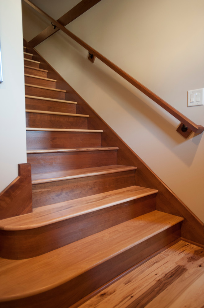 Inspiration for a traditional wood staircase in Other with wood risers.