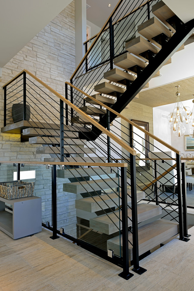 This is an example of a large contemporary concrete l-shaped staircase in Denver with open risers.