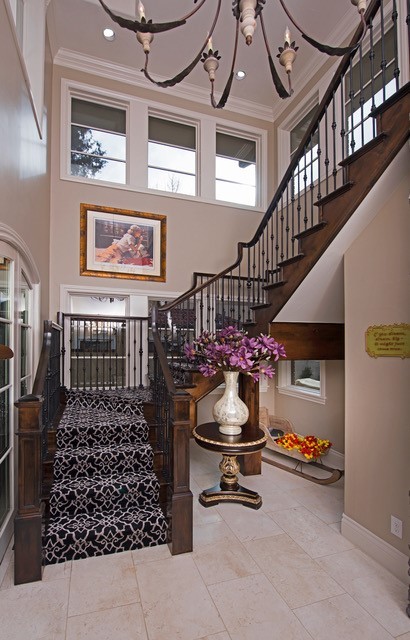 Example of a large tuscan wooden curved staircase design in Denver