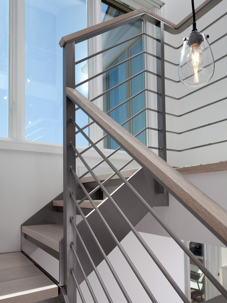 Идея дизайна: лестница на больцах в современном стиле с деревянными ступенями и металлическими перилами без подступенок