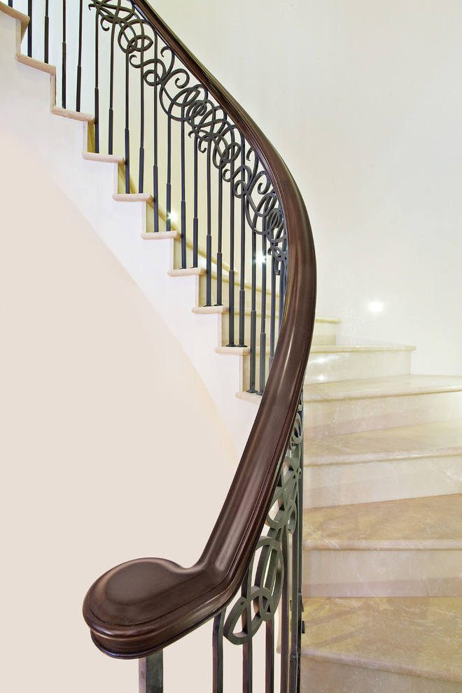 This is an example of an expansive classic metal spiral staircase in London with metal risers.