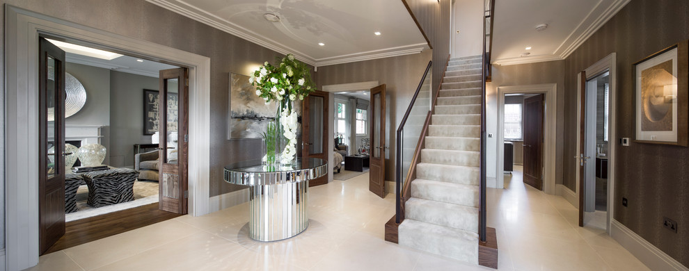 Photo of a large contemporary carpeted straight staircase in London with carpeted risers.