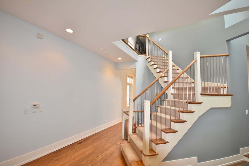 Inspiration for a mid-sized contemporary carpeted l-shaped wood railing staircase remodel in Chicago with wooden risers
