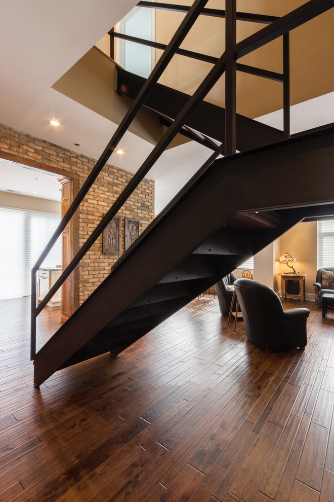 Inspiration for a large contemporary wood u-shaped staircase in Chicago with metal risers.