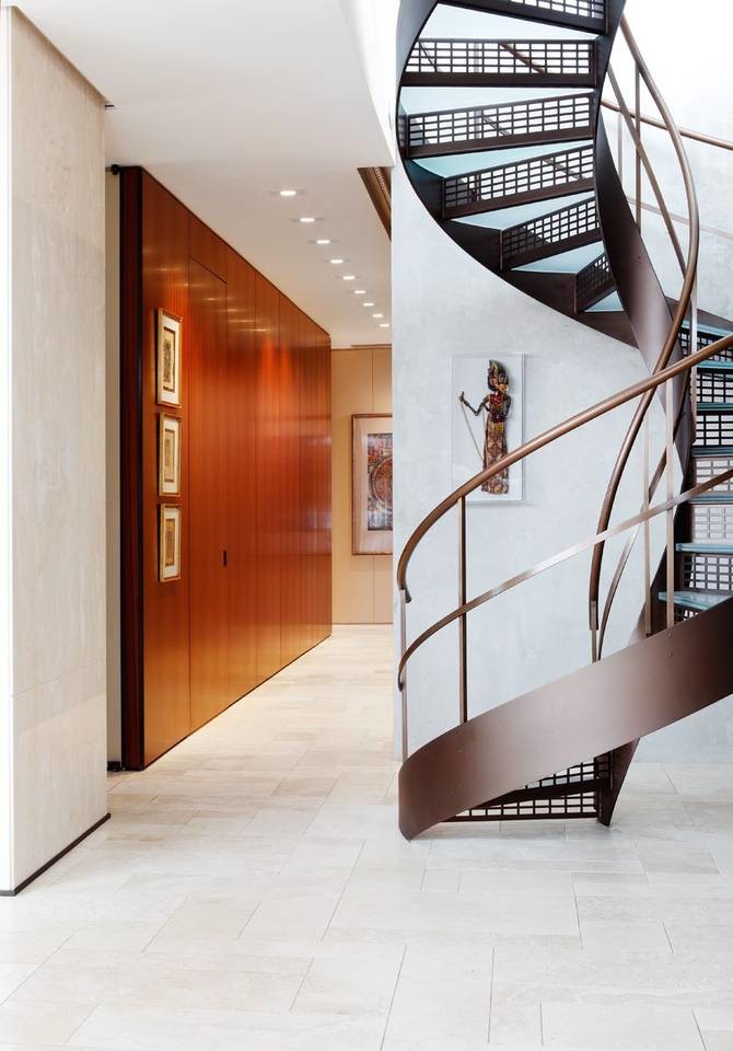 Design ideas for a large contemporary glass spiral staircase in Chicago with metal risers.