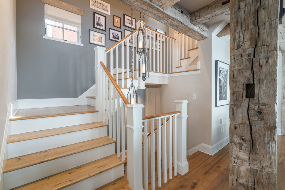 Farmhouse wooden l-shaped wood railing staircase photo in Denver with painted risers