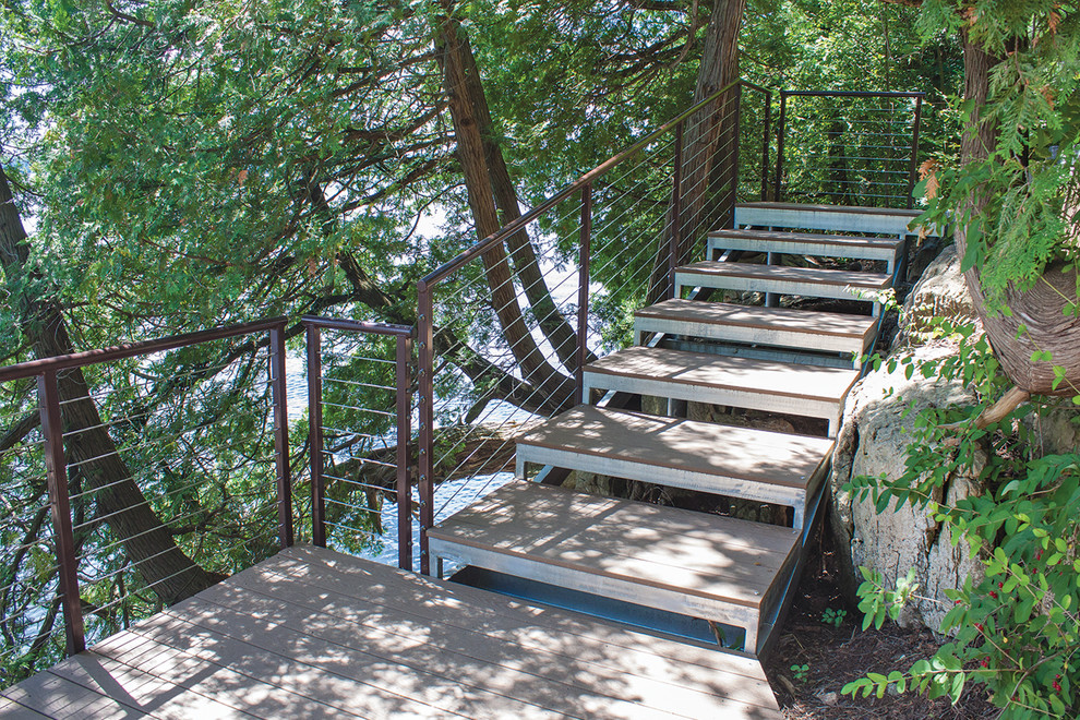 Large elegant metal straight staircase photo in New York with wooden risers