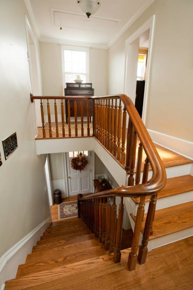 Example of a mid-sized classic wooden straight wood railing staircase design in Other with wooden risers