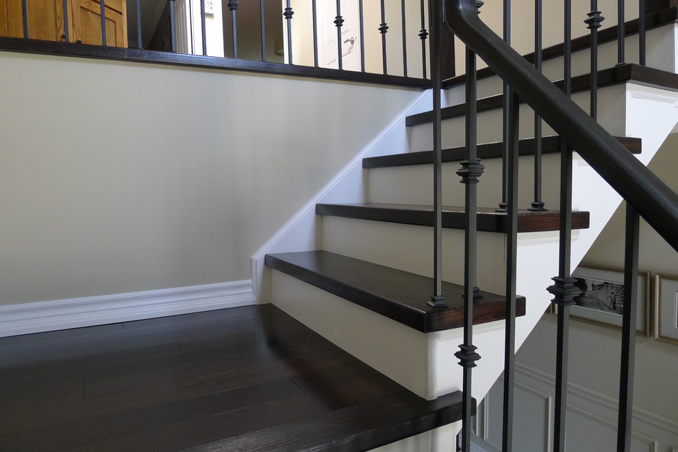close-up of Dark hardwood stairs white risers - Burlington ...