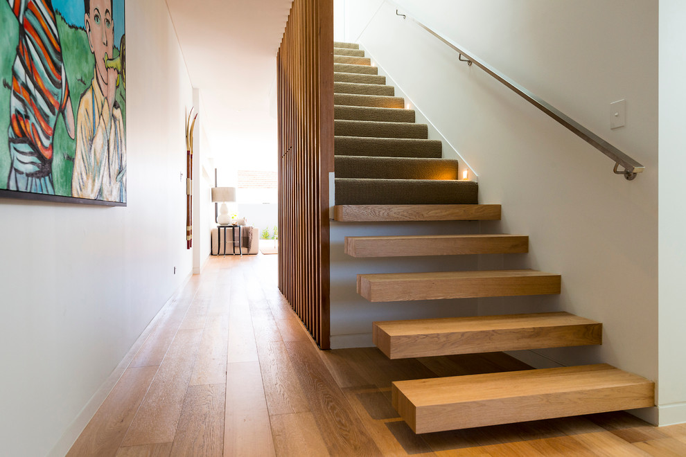 This is an example of a contemporary staircase in Other with feature lighting.