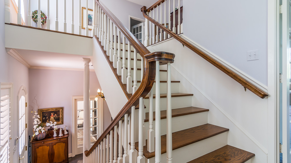 Inspiration for a timeless wooden u-shaped staircase remodel in Austin with painted risers