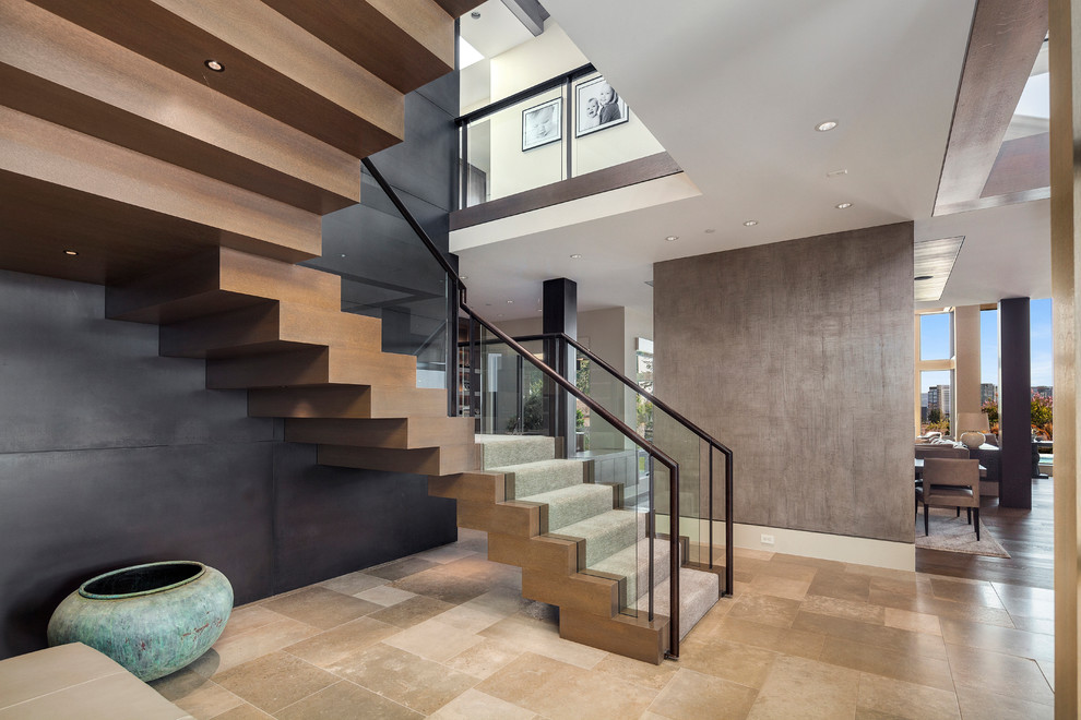 Example of a trendy wooden u-shaped glass railing staircase design in Other with wooden risers