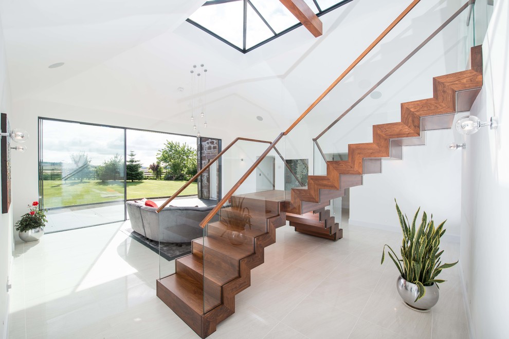 This is an example of a medium sized contemporary wood l-shaped glass railing staircase in Other with wood risers.