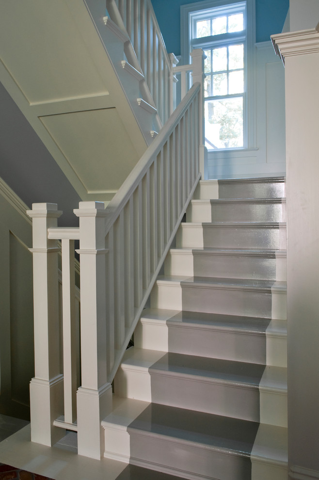 Staircase - mid-sized coastal wooden u-shaped wood railing and wainscoting staircase idea in New York with wooden risers