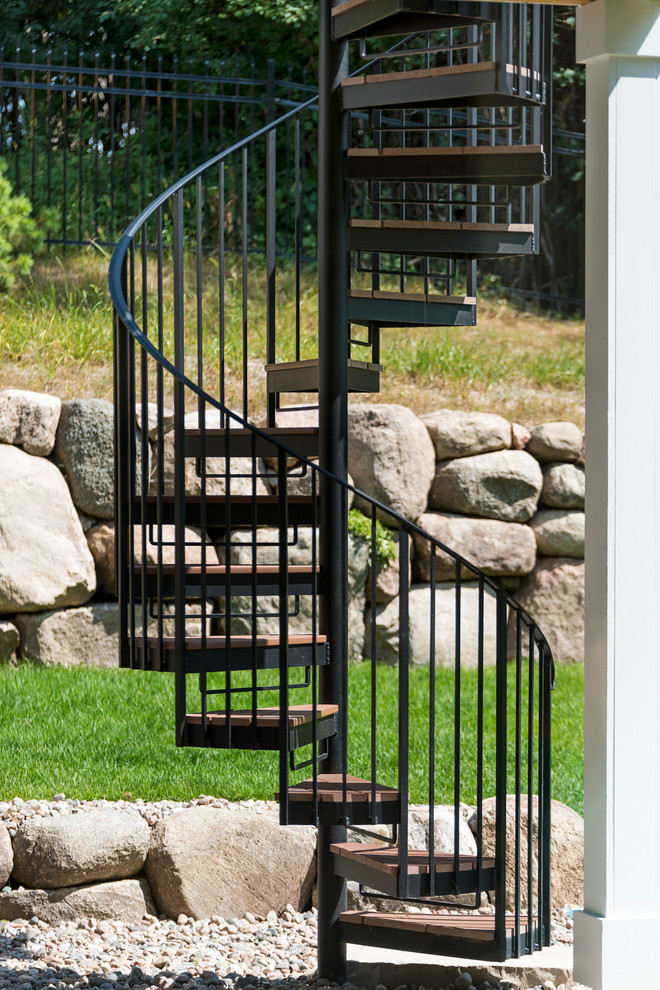 Inspiration for a medium sized nautical spiral metal railing staircase in Minneapolis with metal risers.