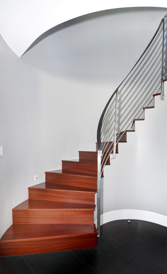 Design ideas for a medium sized modern wood curved metal railing staircase in Orange County with wood risers.