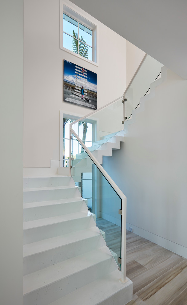 Inspiration for a large modern concrete l-shaped staircase in Miami with concrete risers.