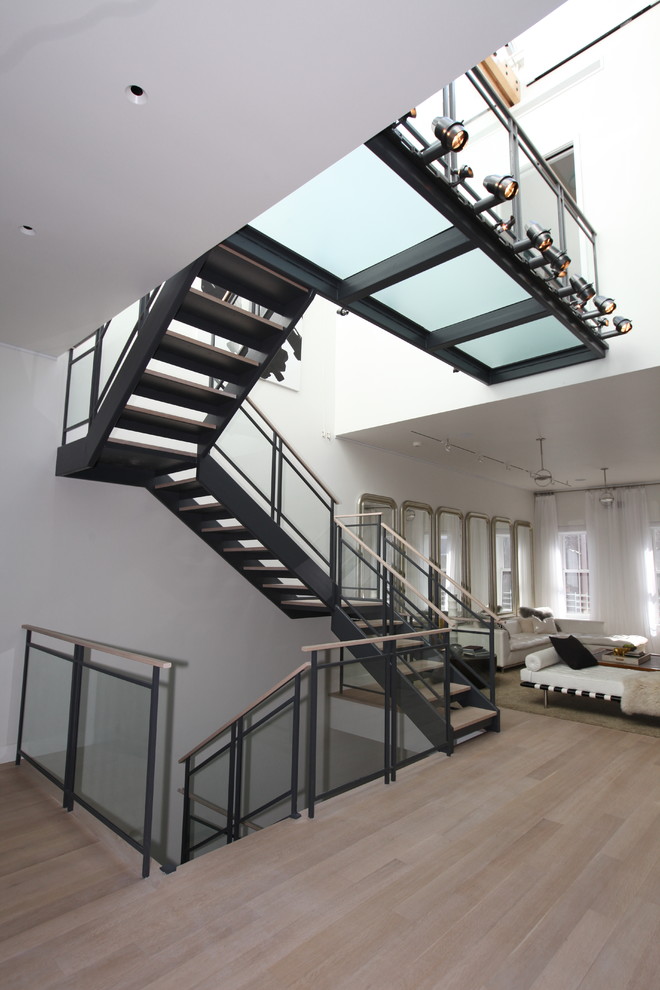Contemporary wood staircase in New York with open risers.