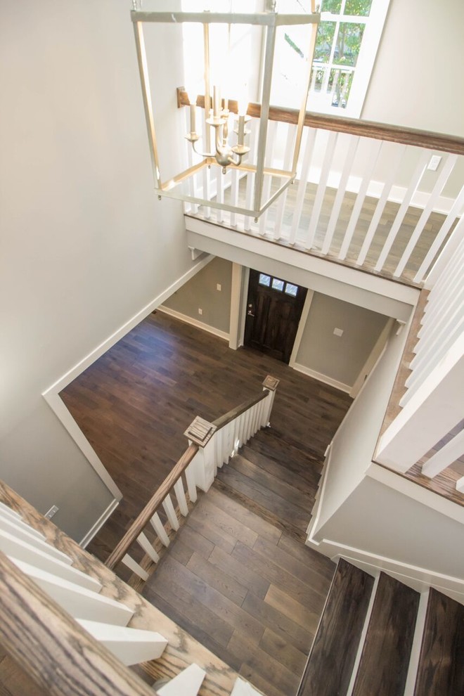 Example of a large classic wooden l-shaped staircase design in Other with painted risers