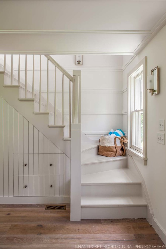 Inspiration for a mid-sized coastal wooden l-shaped staircase remodel in Boston with wooden risers