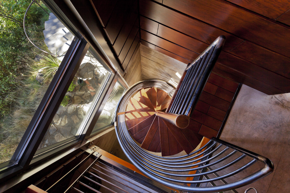 Réalisation d'un grand escalier sans contremarche hélicoïdal minimaliste avec des marches en bois.