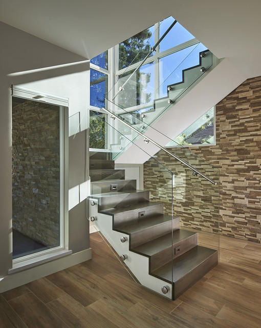 Design ideas for a large contemporary wood l-shaped glass railing staircase in San Francisco with wood risers.