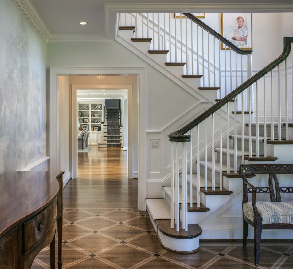 Photo of a classic carpeted l-shaped wood railing staircase in Portland with painted wood risers.