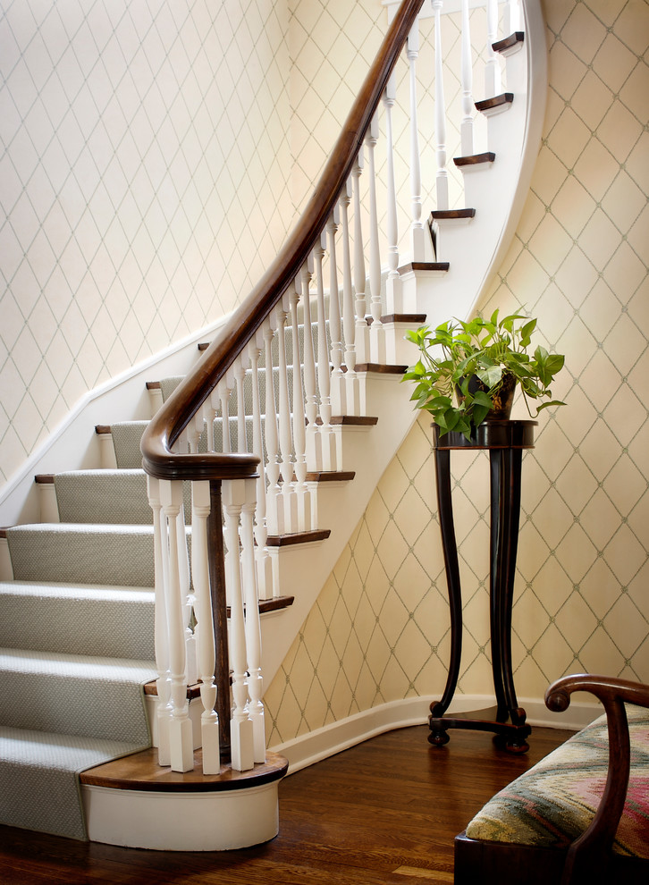 Elegant wooden curved wood railing staircase photo in Chicago with wooden risers