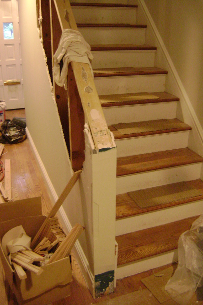 This is an example of a small contemporary wood straight staircase in St Louis with painted wood risers.